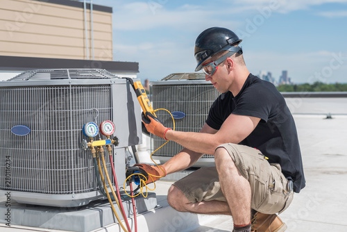 Hvac tech looking at a  multimeter photo