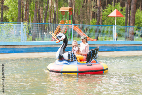 Mom and daughter ride on the water attraction