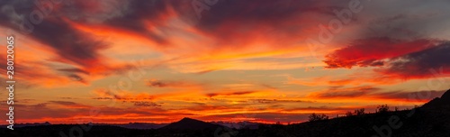 A sunset over a distant mountain in the Sonoran Desert of Arizona panorama © Jason Yoder