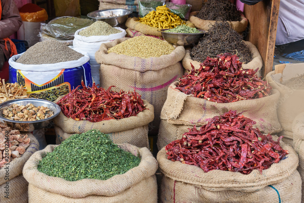 Bags and sacks with spices, seeds, roots for sale at local market in Bikaner. India