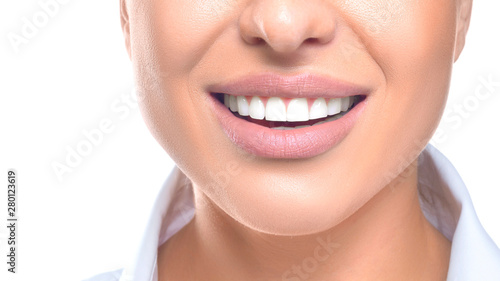 Close up photo of a woman smiling. Teeth whitening and health concept