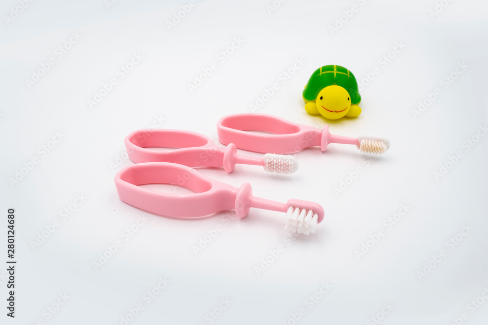 Baby 3 steps pink tooth brushes isolated on white background. Dental teeth brush. Baby 3 steps pink tooth brushes isolated on white background. Dental teeth brush.