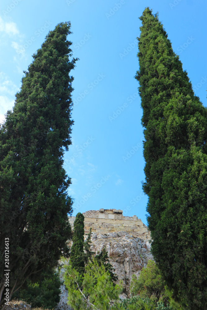 View to Acropolis of Athens from below between two big cypress