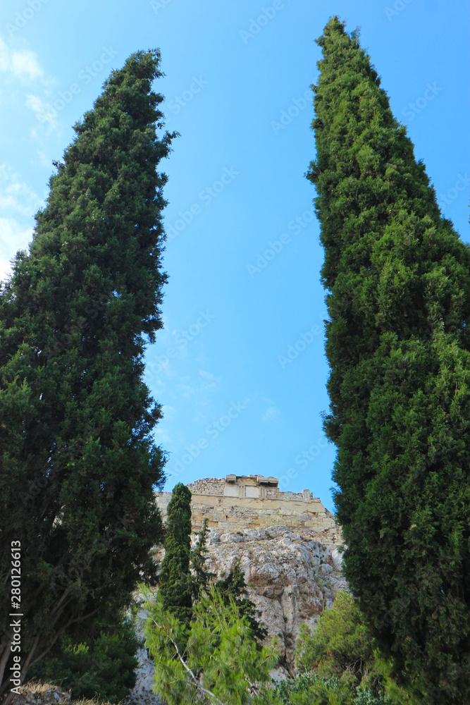 Fototapeta premium View to Acropolis of Athens from below between two big cypress