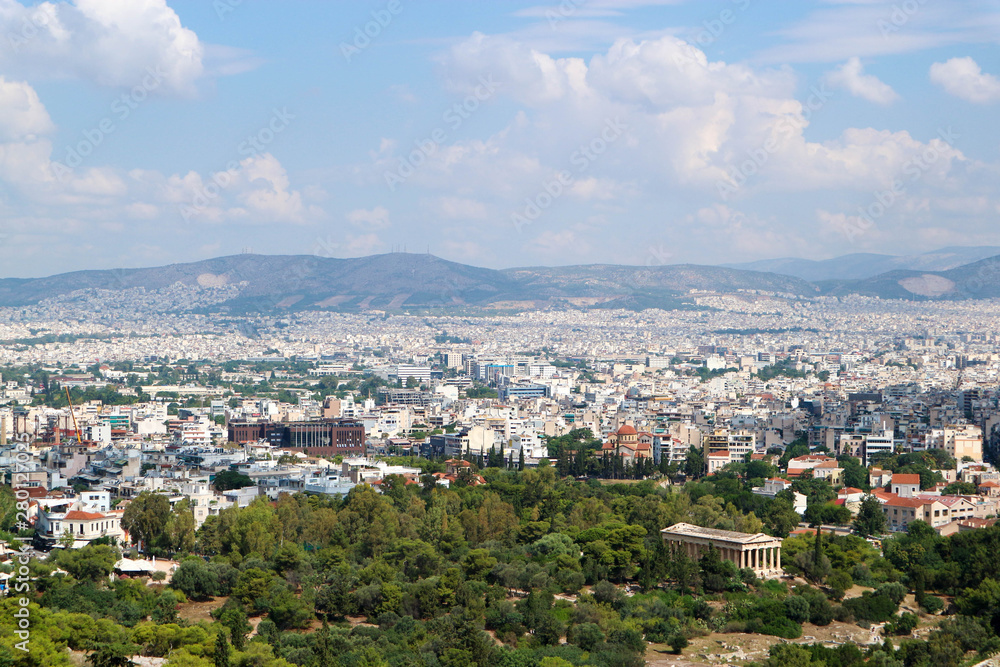 Scenic panoramic aerial view of the white city Athens Greece from acropolis under summer blue sky with clouds