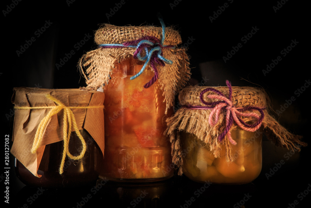 closeup three glass jars of natural jam with rustic decoration