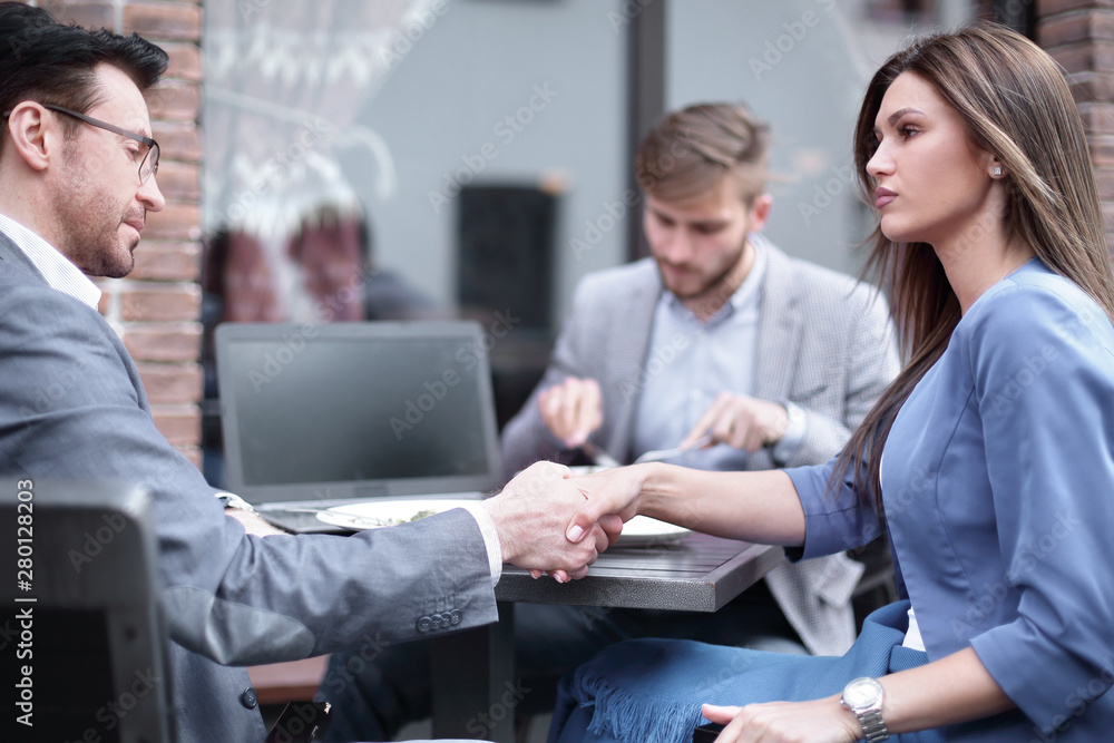 handshake business partners in an informal setting handshake business partners in an informal setting