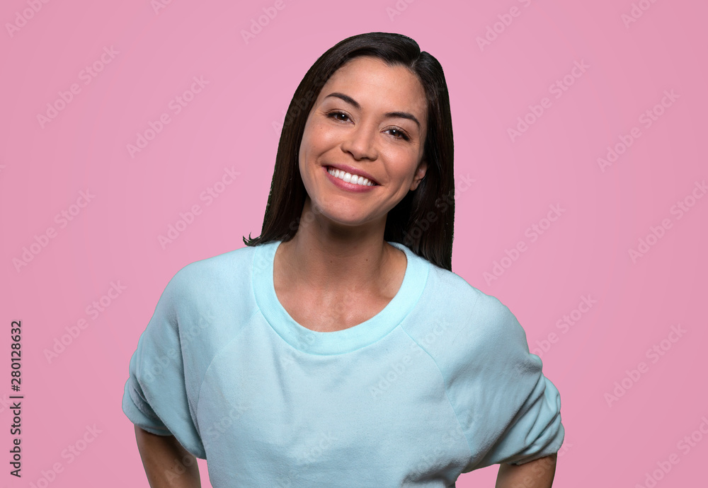 Fun loving cheerful warm and friendly female with perfect smile, isolated on pink background Fun loving cheerful warm and friendly female with perfect smile, isolated on pink background