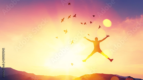 Happy man jumping on top of mountain and sunset sky star with birds fly abstract background.