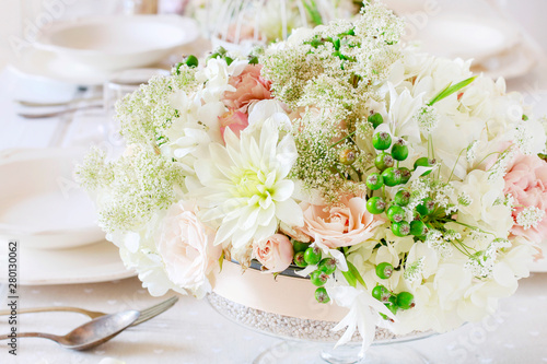 Floral decorations on summer party table. Centerpiece with rose  dahlia and hortensia flowers