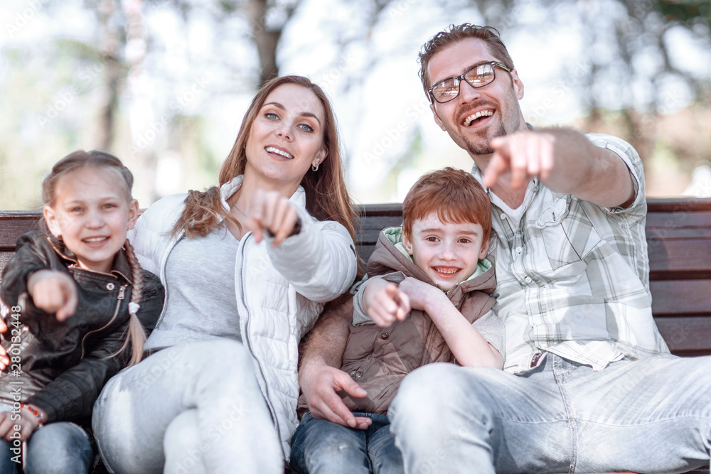 close up.happy family pointing at you