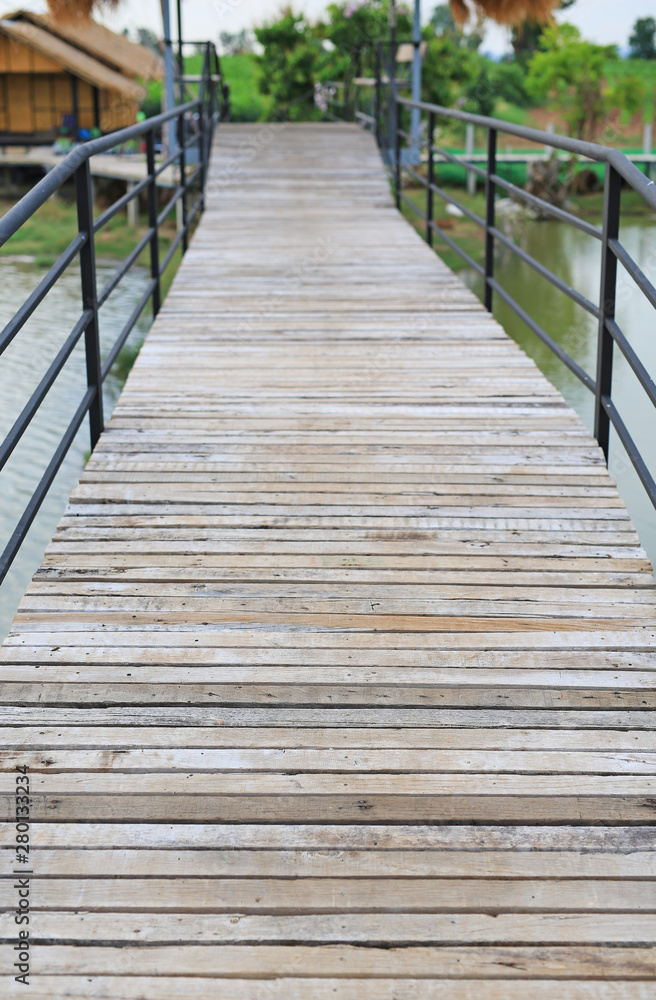Wooden bridge crossing river to countryside pavilion in Thailand. Wooden bridge crossing river to countryside pavilion in Thailand.