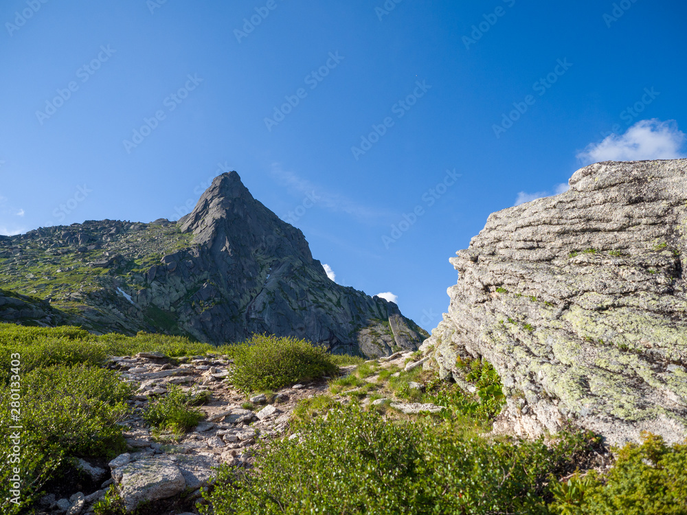 The trail to the pass among the ancient stones in the Ergaki nature park. Siberian Mountains Western Sayan
