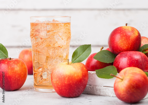 Glass of homemade organic apple cider with fresh apples in box on wooden background. Space for text