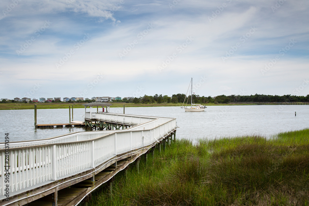 Obraz premium river dock with a sail boat