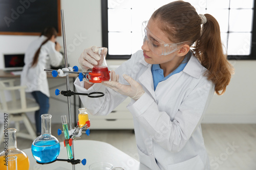 Smart pupil making experiment in chemistry class