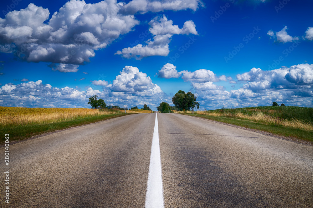 Low angle view of a tarred road receding