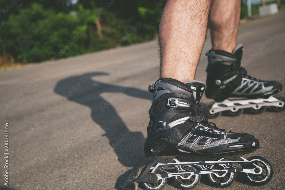 Fotografie man with inline skates skating on the street
