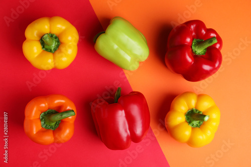 Flat lay composition with ripe bell peppers on color background