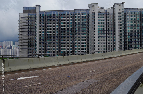 Road surface Hong Kong highway with desne highrise apartment building complex in background photo