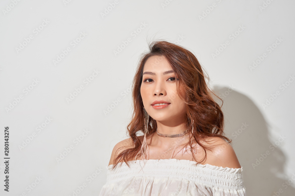 Gorgeous young model. Close up of an attractive girl of Asian appearance on white background Gorgeous young model. Close up of an attractive girl of Asian appearance on white background