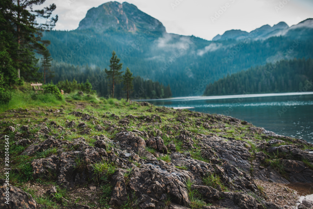  Peacefull landscape with lake, reflection, mountains and forest in cloudle foggy atmosphere. Durmitor national park in Montenegro, lake Crno