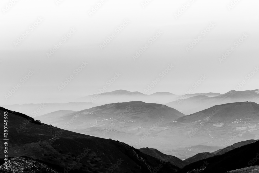 Dusk, with mountains layers and mist between them