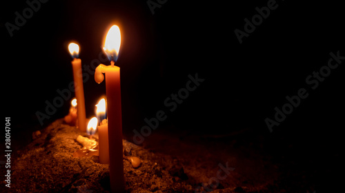 Group candlelight is bright light on sand in dark night. Religion concept