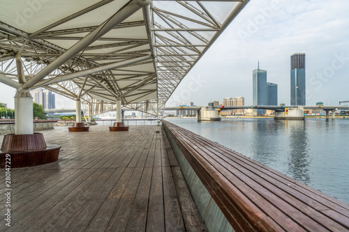 Empty wooden footpath front modern building. © hallojulie