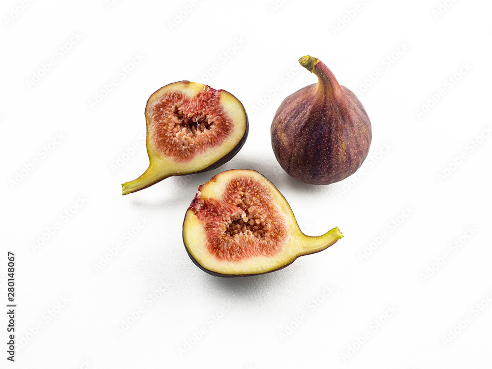The purple fruits of ripe figs are whole and sliced. Isolated The purple fruits of ripe figs are whole and sliced. Isolated
