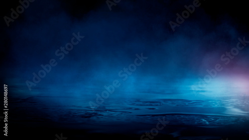 Wet asphalt, reflection of neon lights, a searchlight, smoke. Abstract light in a dark empty street with smoke, smog. Dark background scene of empty street, night view, night city. © MiaStendal