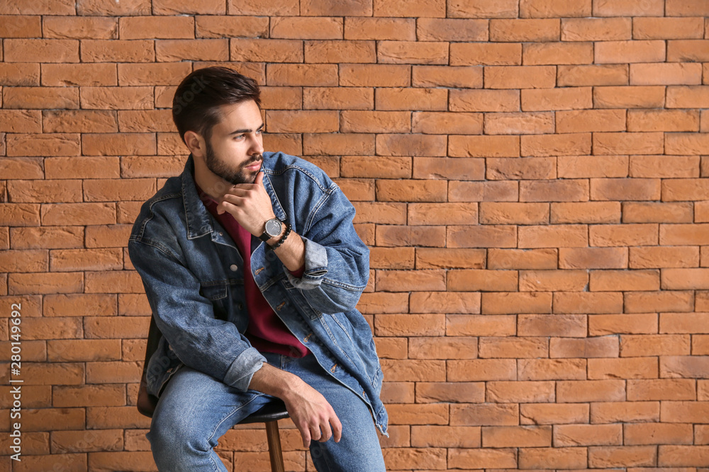 Fashionable young man near brick wall Fashionable young man near brick wall