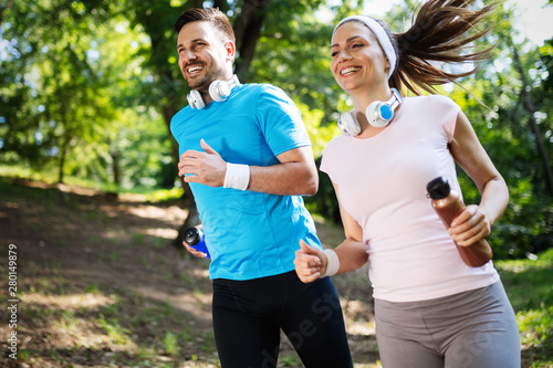 Fototapeta Naklejka Na Ścianę i Meble -  Happy couple running and exercising together outdoor