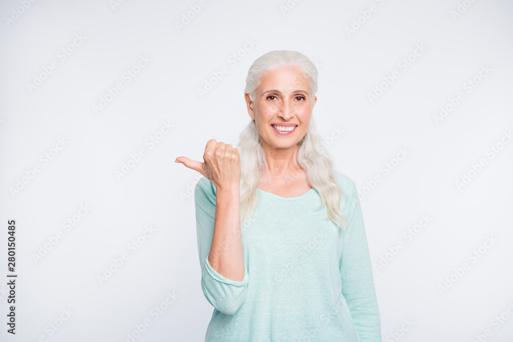 Portrait of confident person showing advertisement with her thumb wearing turquoise jumper isolated over white background Portrait of confident person showing advertisement with her thumb wearing turquoise jumper isolated over white background
