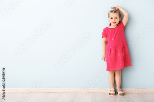 Little girl measuring heigh...