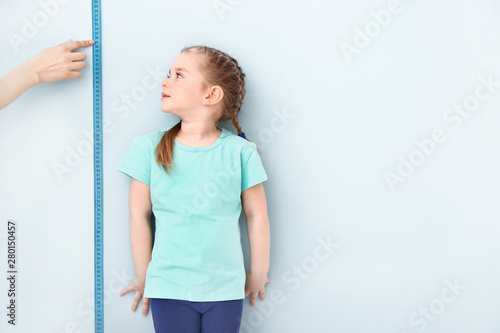 Mother measuring height of ...
