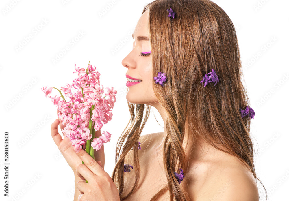 Naklejka premium Beautiful young woman with hyacinth flowers on white background