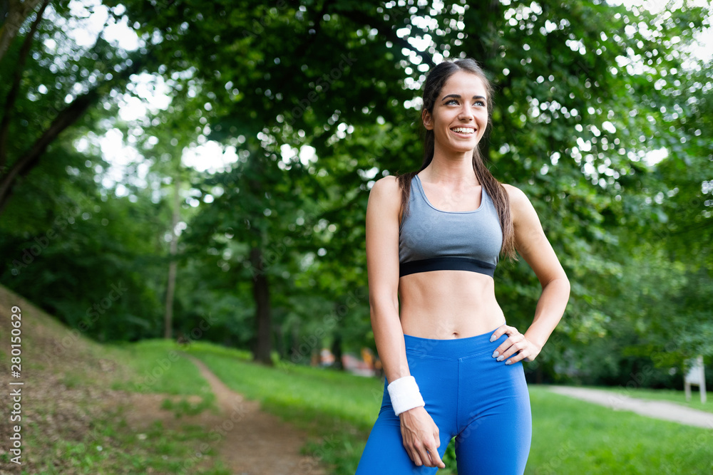 Sporty woman runner jogging during outdoor workout in park Sporty woman runner jogging during outdoor workout in park
