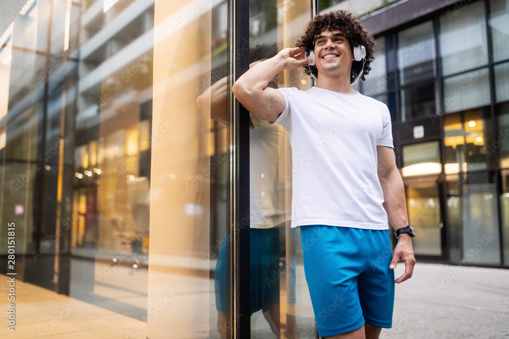 Fototapeta premium Happy sporty fit man running to stay healthy outdoor