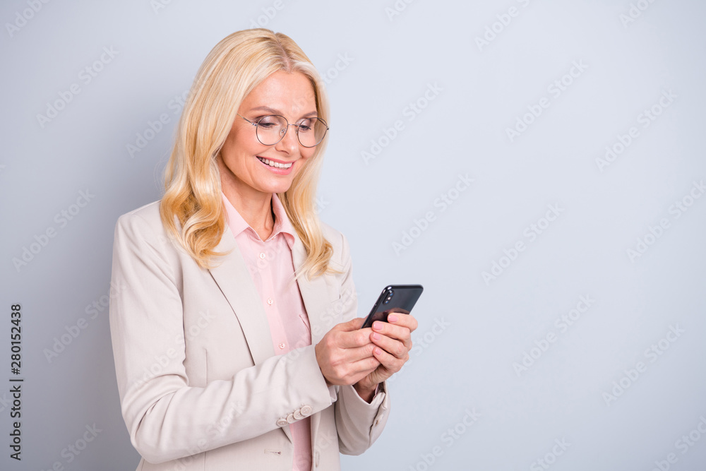 Portrait of her she nice attractive lovely stylish cheerful cheery glad wavy-haired lady holding in hands device web site surfing free time isolated over light white gray pastel background Portrait of her she nice attractive lovely stylish cheerful cheery glad wavy-haired lady holding in hands device web site surfing free time isolated over light white gray pastel background