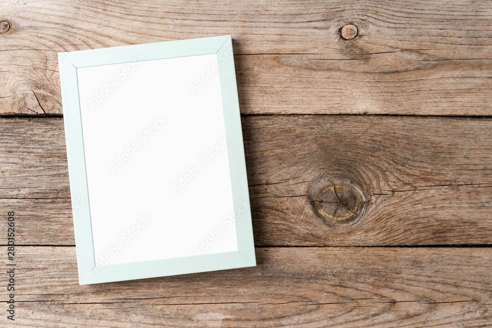 Empty photo frame mockup on wooden background Empty photo frame mockup on wooden background