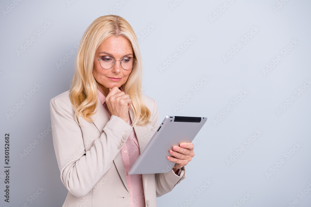 Portrait of her she nice-looking attractive lovely stylish focused concentrated peaceful wavy-haired lady holding in hands e-book reading news isolated over light white gray pastel background Portrait of her she nice-looking attractive lovely stylish focused concentrated peaceful wavy-haired lady holding in hands e-book reading news isolated over light white gray pastel background