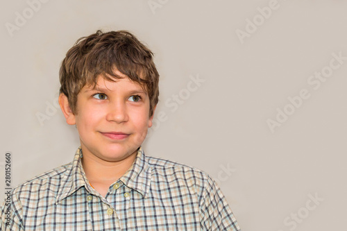 portrait of a teenage boy on a gray background