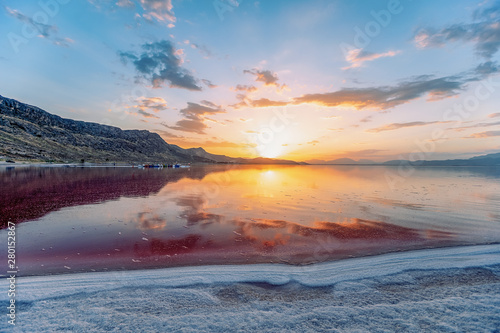 beautiful landscape and sunset with sky reflection over salty Lake Maharlu in Iran, Fars Province near Shiraz city, with incredibly red water like blood photo