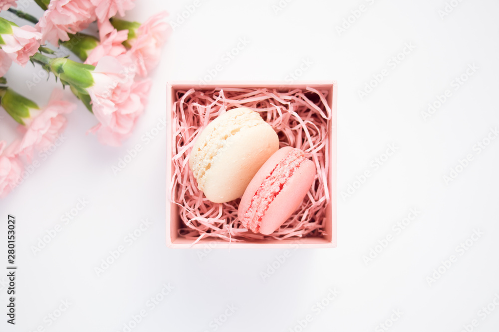 Beautiful carnation flowers and two macaroons in decorative box. Beautiful carnation flowers and two macaroons in decorative box.