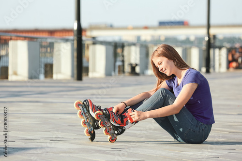 Teenage girl putting on rol...