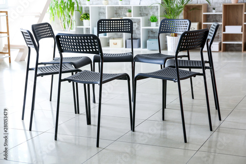 Empty chairs prepared for group therapy in psychologist's office