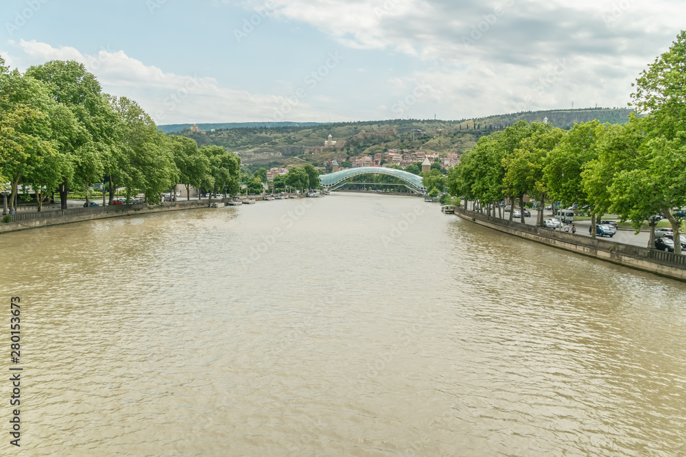 Peace Bridge in Tbilisi. View of the futuristic bridge of glass and metal across the Kura River
