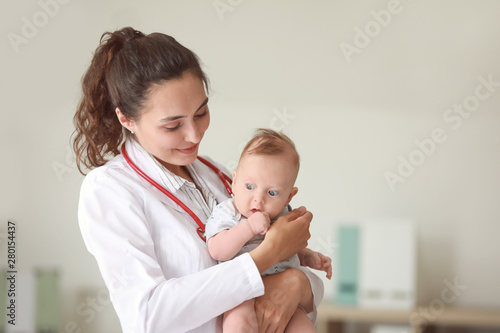 Pediatrician with cute litt...