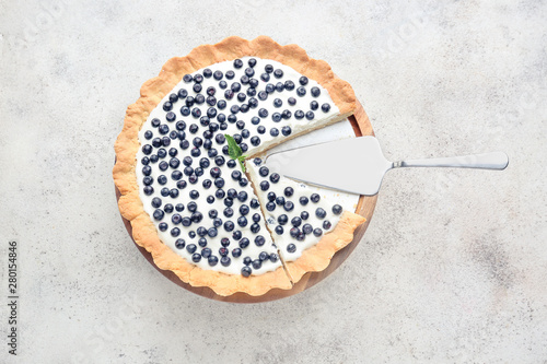 Tasty bilberry pie on grey background